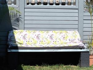 a bench with a pillow on top of it at Travelers Home in Richards Bay