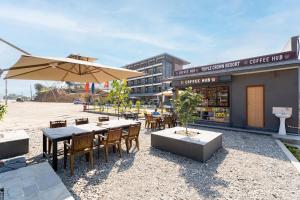a restaurant with tables and chairs and an umbrella at Triple Crown Resort in Dhāding