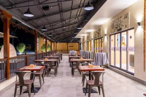 a row of tables and chairs in a restaurant at Triple Crown Resort in Dhāding