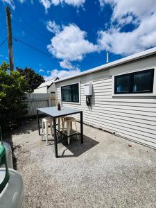 a table and chairs in front of a trailer at Modern 1 bedroom guest house in Upper Hutt +6 photos