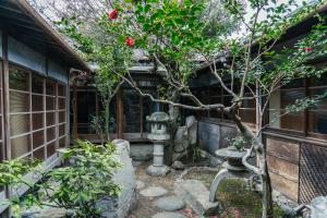 a garden with a small tree in front of a building at うみの図書館 in Sanuki