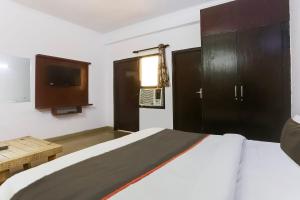 Postel nebo postele na pokoji v ubytování Hotel O Happy Residency