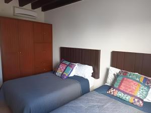 two beds sitting next to each other in a bedroom at Las Quintas, San José del Cabo in San José del Cabo +23 photos