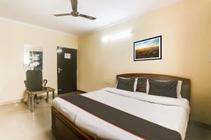 Postel nebo postele na pokoji v ubytování Hotel O Happy Residency
