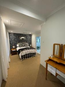 a bedroom with a bed and a wall at Lavender Cottage in Hillcrest