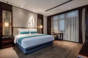 Postel nebo postele na pokoji v ubytování Xinghuacun Hotel + 37 fotografií