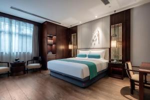 Postelja oz. postelje v sobi nastanitve Xinghuacun Hotel