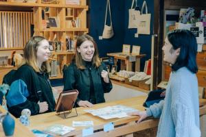 three women sitting around a table in a book store at うみの図書館 in Sanuki