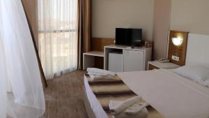 Postel nebo postele na pokoji v ubytování Çeşme Farm Hotel