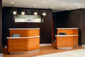 a lobby with two wooden kiosks in a building at Courtyard Baton Rouge South in Baton Rouge