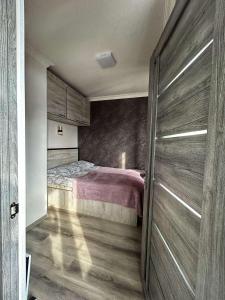 a bedroom with a bed and a sliding door at Квартира in Jermuk