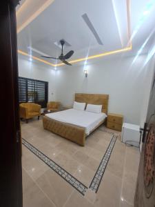 a bedroom with a bed and a ceiling fan at Haven homes in Islamabad