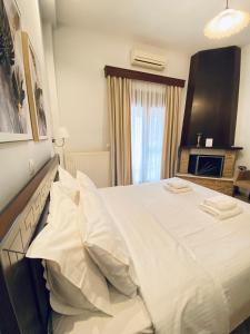 Posteľ alebo postele v izbe v ubytovaní Ξενώνας Ρόδον
