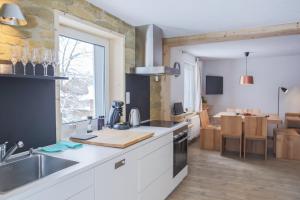 a kitchen with a sink and a stove top oven at Kuckucksnest Neustadt in Titisee-Neustadt