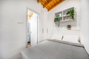 a white bedroom with a bed and a window at Olga Premium Apartments in Limassol +24 photos