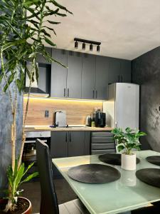a kitchen with a table and a refrigerator at Апартамент 8 in Varna City