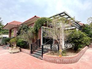 a house with a staircase in front of it at J'adore Garden House Vinh Yen in Nhân Mỹ