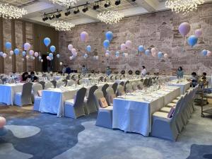 a banquet hall with white tables and balloons at 开芯国际大酒店 in Guangzhou +82 photos