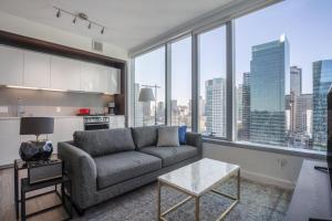 a living room with a couch and large windows at Rincon Hill 1BR w Gym Steam Room nr SVB FB SFO-208 in San Francisco