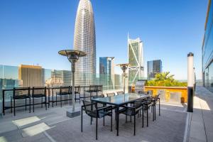 a patio with tables and chairs and a city skyline at Rincon Hill 1BR w Gym Steam Room nr SVB FB SFO-208 in San Francisco