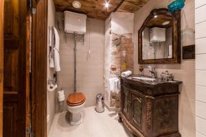 a bathroom with a wooden sink and a toilet at Viru Lux Apartment in Tallinn
