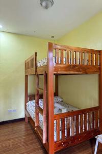 two bunk beds in a room with a ceiling at Jhunlyn Rooms for Rent Tagaytay in Tagaytay