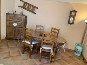 a dining room with a wooden table and chairs at MAISON Cornimont in Cornimont