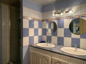 a bathroom with two sinks and two mirrors at MAISON Cornimont in Cornimont +11 photos