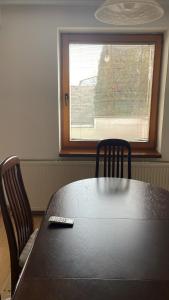a table with two chairs and a remote control on top at BT Lux apartment 2 in Skopje