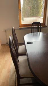 a dining room table and chairs with a window at BT Lux apartment 2 in Skopje
