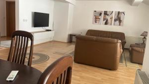a living room with a couch and a television at BT Lux apartment 2 in Skopje