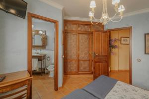 a bedroom with a bed and a bathroom with a sink at La Panera in Castrojimeno