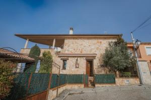 a house with a fence in front of it at La Panera in Castrojimeno