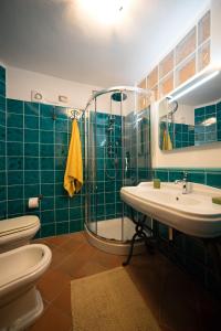 a bathroom with a toilet and a sink and a shower at Casa Spiga in Cagliari