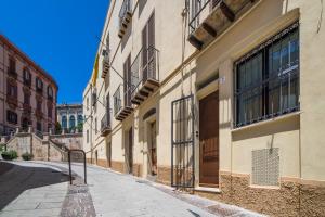 an empty street in a city with buildings at Casa Spiga in Cagliari