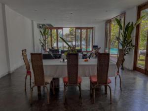 a dining room with a table and chairs at Red Mangrove in Bentota
