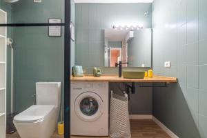a bathroom with a washing machine and a sink at Loft con estilo y supercéntrico in Castellón de la Plana +12 photos