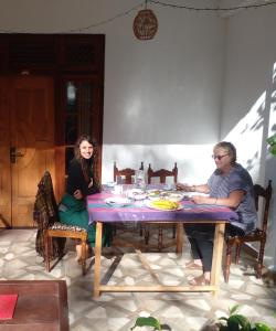 a man and a woman sitting at a table at New Relax Inn Ella in Ella