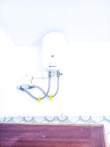 a pipe hanging on a wall in a room at 2 bedroom apt 323 Kisimani Heights, Mombasa, Kisimani in Mombasa