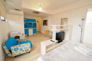 a room with a bed and a living room at Iassium Residence Iasi in Iaşi
