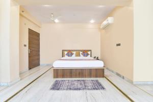 a bedroom with a large bed in a room at FabHotel Pearl Square in Jaipur