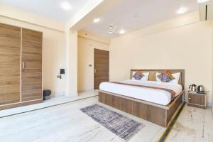 a bedroom with a large bed in a room at FabHotel Pearl Square in Jaipur