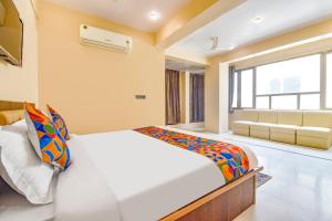 a bedroom with a bed and a couch at FabHotel Pearl Square in Jaipur +43 photos
