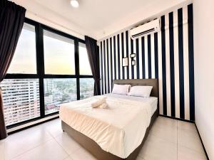 a bedroom with a bed and a large window at cozy luxury suites urban in penang city view 10pax in George Town +74 photos