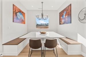 a dining room with a white table and chairs at Slickrock Shore townhouse in St. George