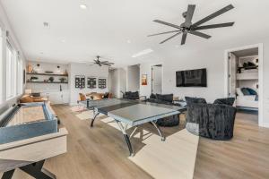 a living room with a ping pong table in it at Slickrock Shore townhouse in St. George