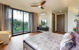 a bedroom with a bed and a large window at HCM CHEONGDAM Villa in Ho Chi Minh City +17 photos