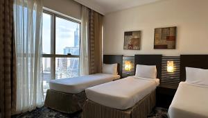 Postel nebo postele na pokoji v ubytování Al Kiswah Tower 5 Hotel