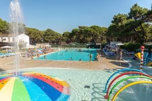 a large swimming pool with people in the water at Camping Alannia Neptuno in Pals