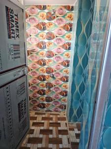 a wall of donuts in a display case at Texoya Zostellers Homestay in Bihār Sharīf